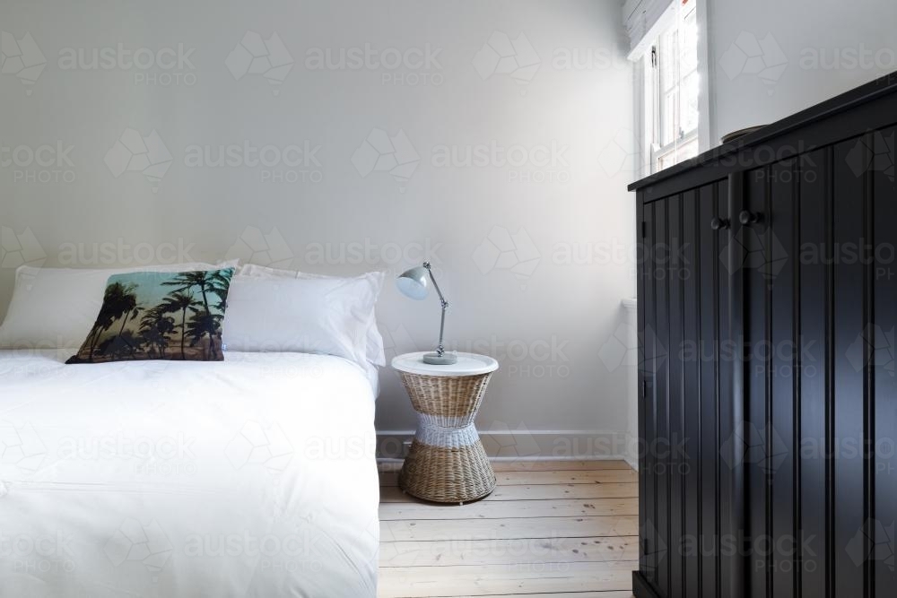 Clean white guest bedroom in modern designer apartment : Austockphoto Clean white guest bedroom in modern designer apartment - Australian Stock Image