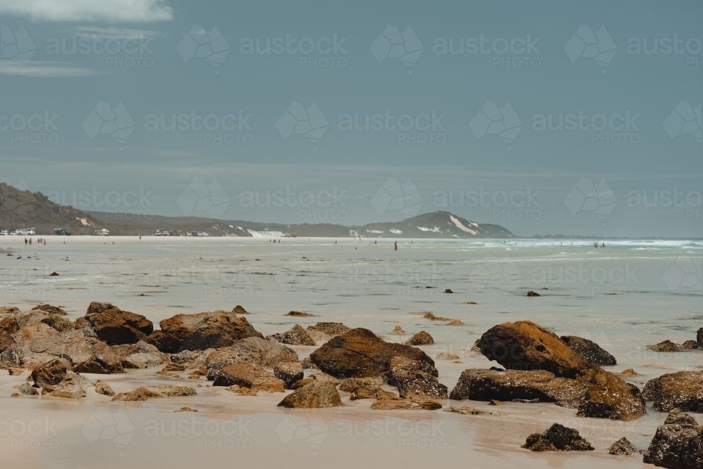 Clear ocean water and sand dunes at the beach near Mulgumpin Camping Area, North Point - Australian Stock Image
