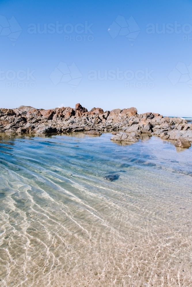 Clear water in a rockpool with ripples - Australian Stock Image