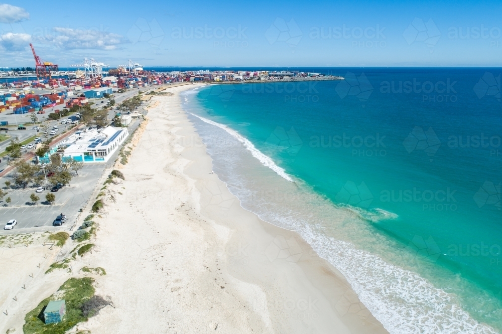 Clear water of Port Beach with Port of Fremantle in background and white sand - Australian Stock Image
