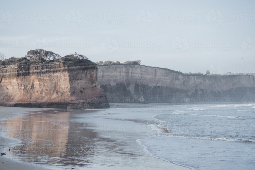 Cliffs on the edge of the ocean on overcast day - Australian Stock Image