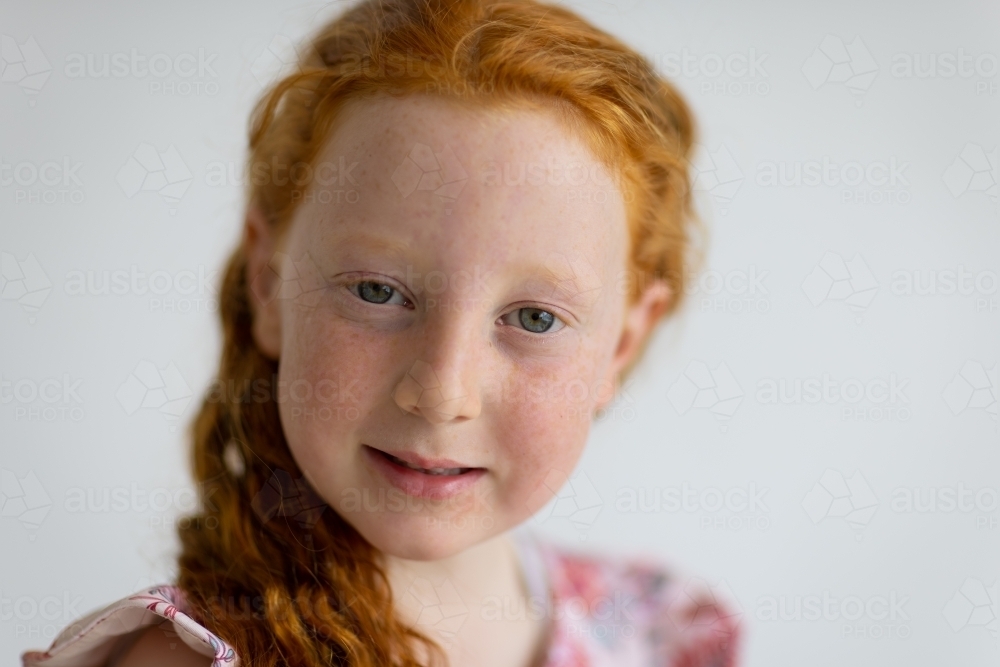 Image of close cropped portrait of freckled child with ginger hair