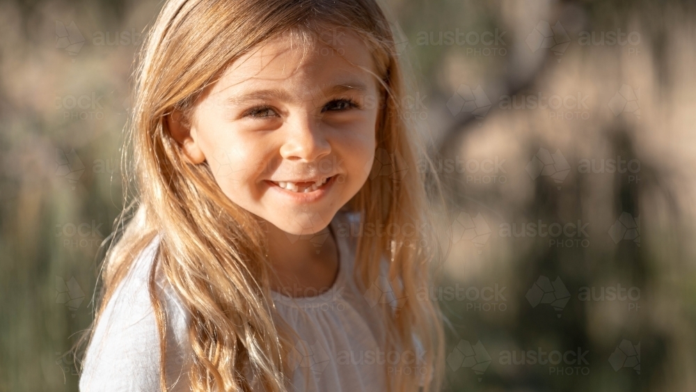 Close of up young girl with front teeth missing - Australian Stock Image