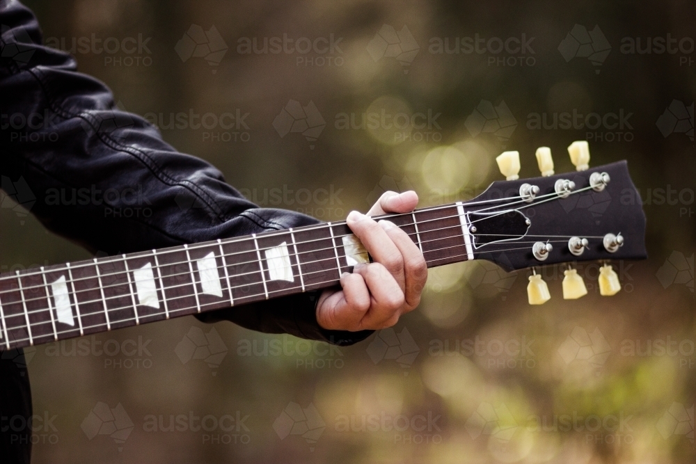 Close up detail of guitar strings and neck - Australian Stock Image