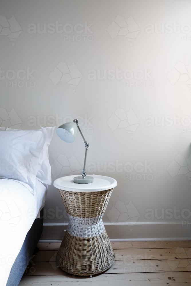 Close up details of bedside table with lamp and copy space - Australian Stock Image