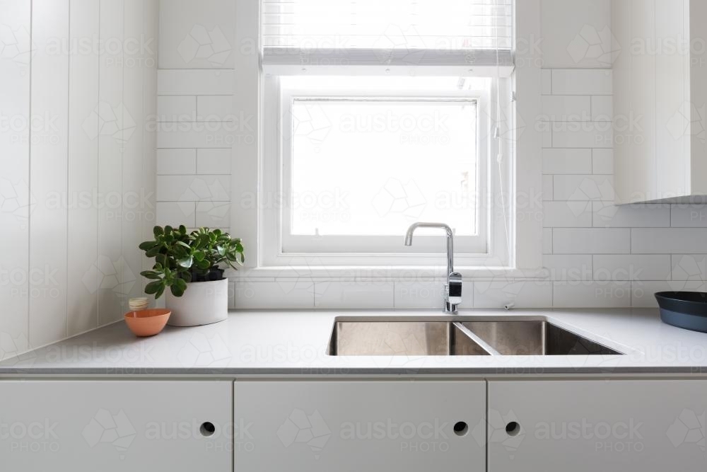 Close up details of contemporary white apartment kitchen with subway tiles - Australian Stock Image