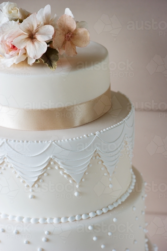 close up details of hollywood glam wedding cake with fondant icing and piping - Australian Stock Image
