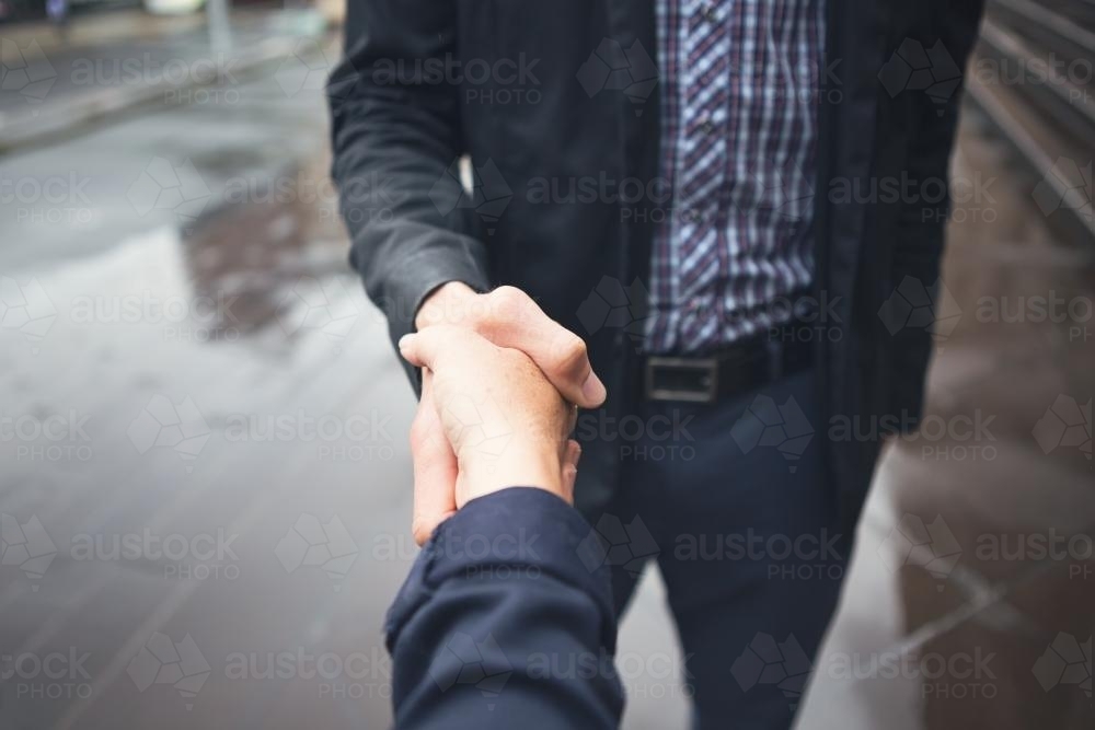 Close up handshake of guy in business casual dress - Australian Stock Image