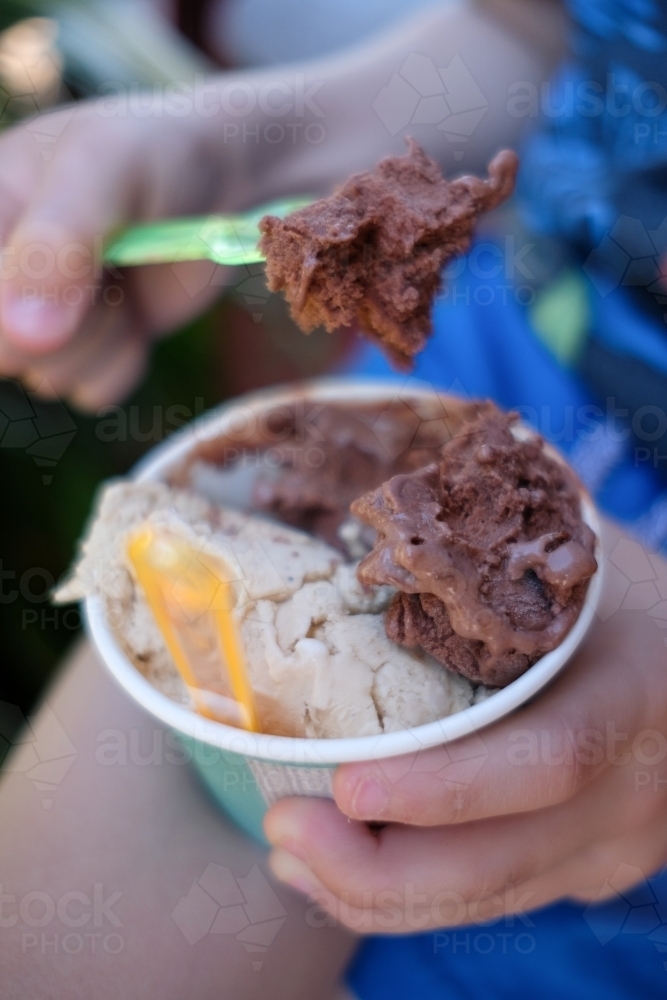 Close up of a boy eating chocolate and coffee gelato in Brisbane - Australian Stock Image