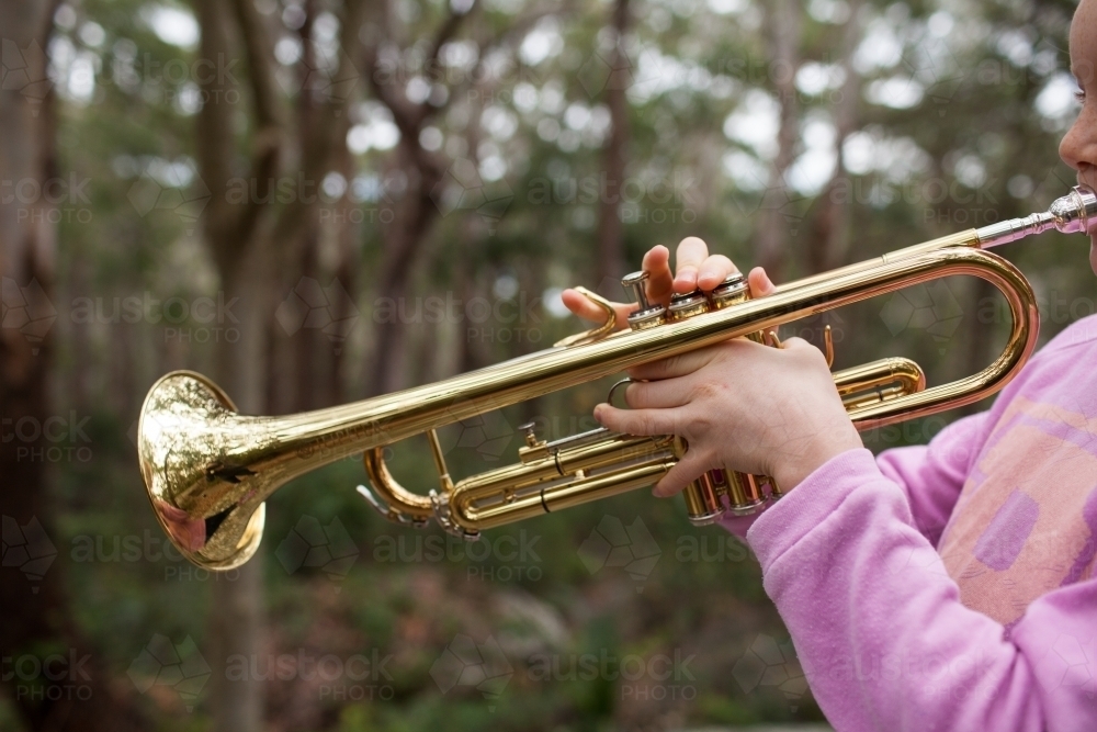 Close up of a girl playing a trumpet - Australian Stock Image