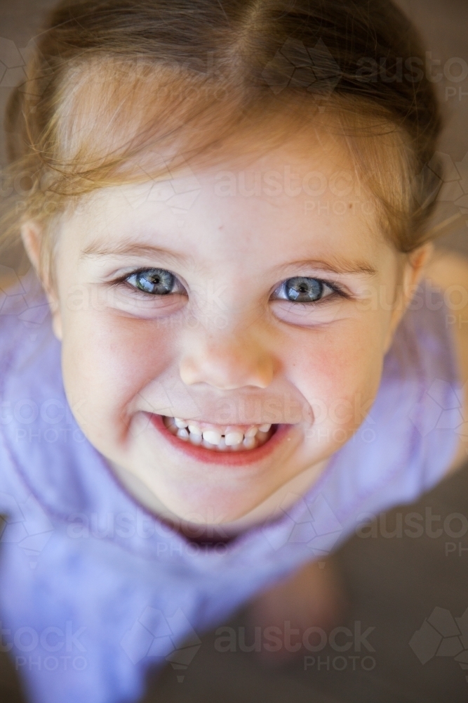 Close up of a happy little girl smiling - Australian Stock Image