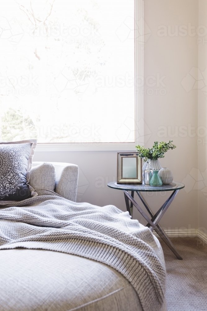 Close up of a luxurious bedroom armchair and side table - Australian Stock Image