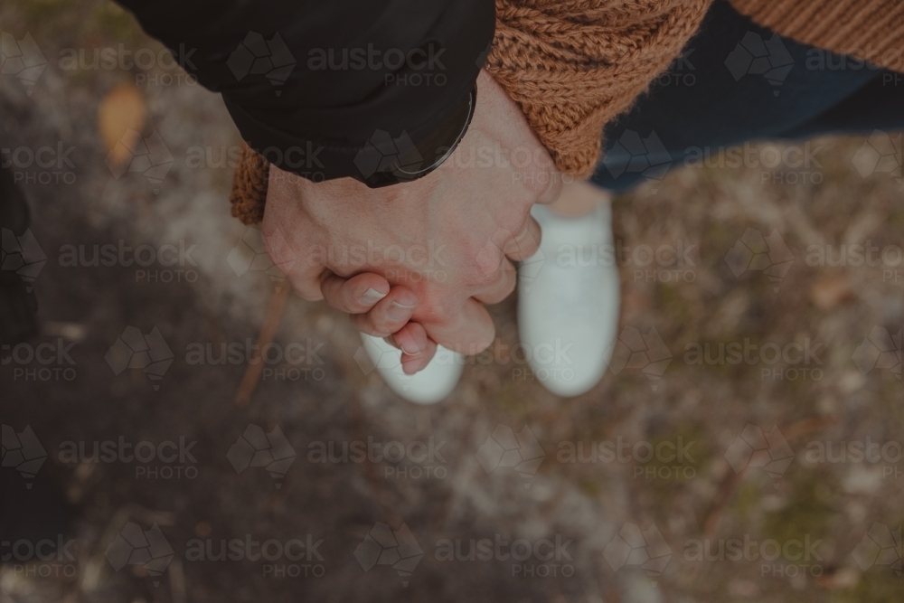 Close-up of a man and woman holding hands - Australian Stock Image