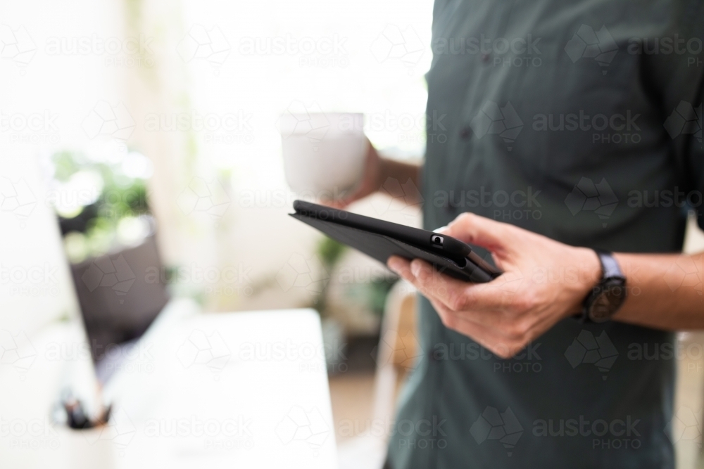 Close-up of a man using an e-device - Australian Stock Image