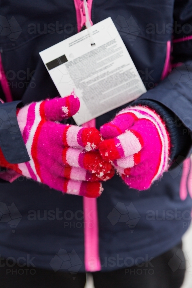 Close up of a pair of pink gloves at the snow - Australian Stock Image