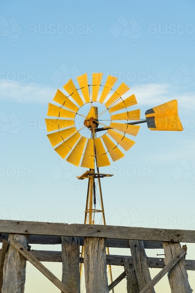 Close up of a windmill and the top of an old wooden tank stand - Australian Stock Image