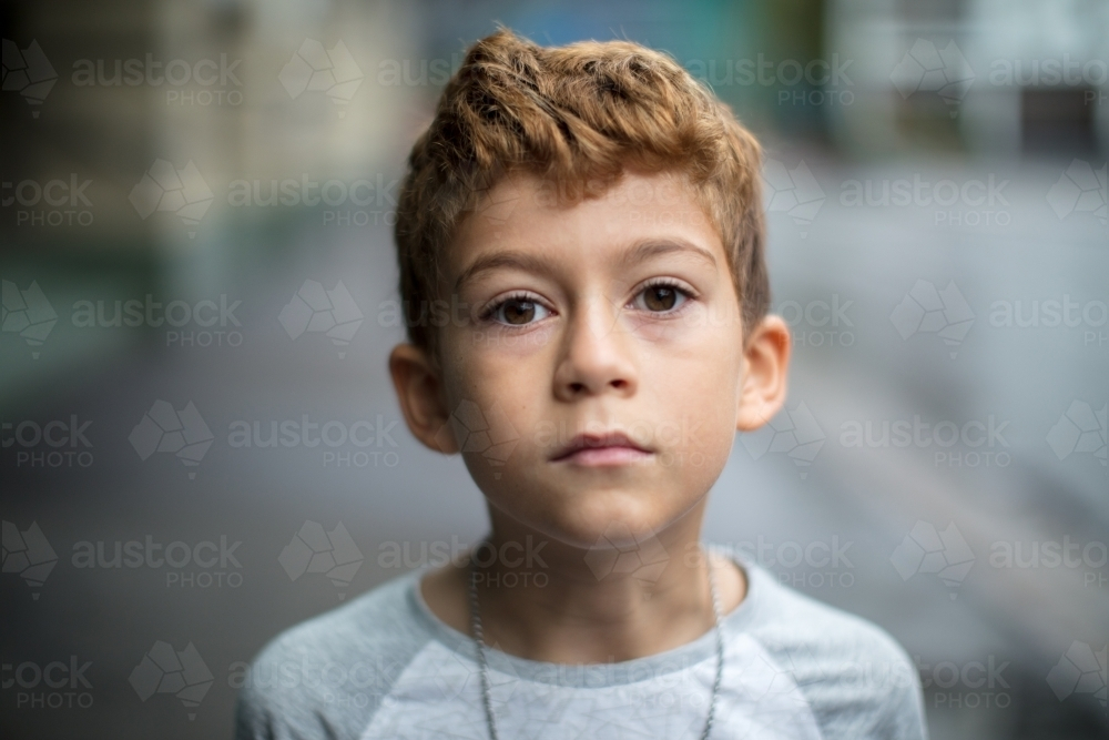Close-up of a young boy with curly hair - Australian Stock Image
