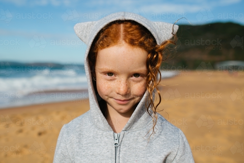 Close up of a young girl in a grey hoodie with ears : Austockphoto Close up of a young girl in a grey hoodie with ears - Australian Stock Image