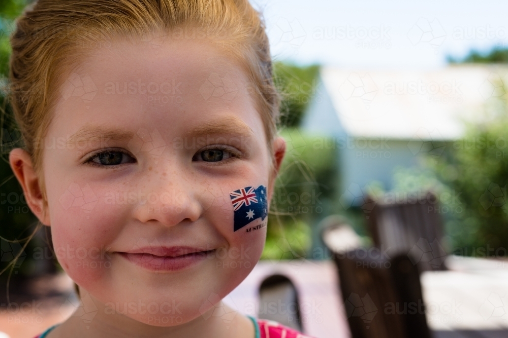 Image of Close up of a young girl smiling with an australian flag ...