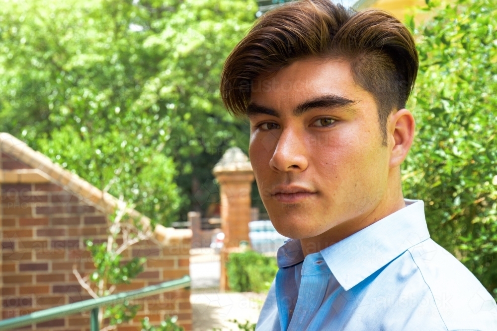 Close up of a young male outdoors wearing a business shirt - Australian Stock Image