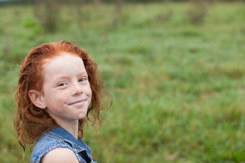 Close up of a young redhead girl smiling - Australian Stock Image
