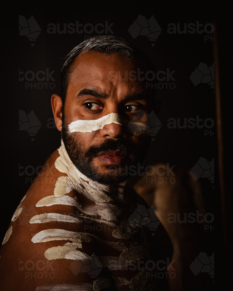 Close-up of aboriginal man with white body paint - Australian Stock Image