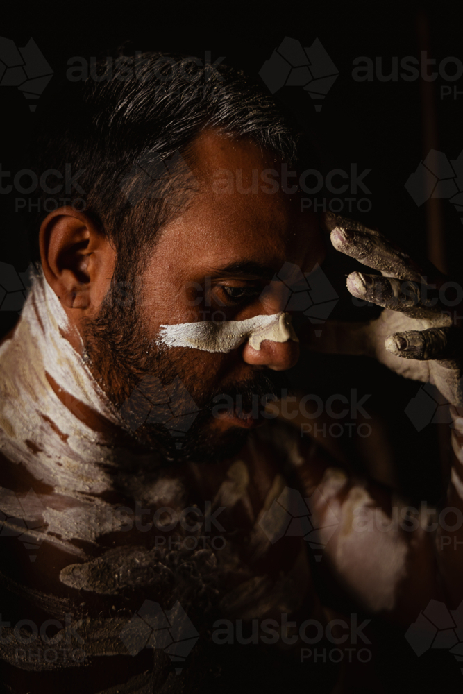 Close-up of aboriginal man with white body paint - Australian Stock Image
