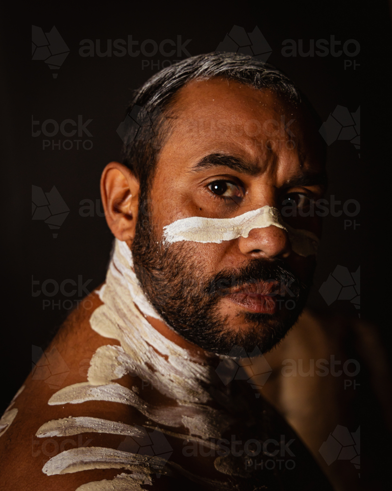 Close-up of aboriginal man with white body paint - Australian Stock Image