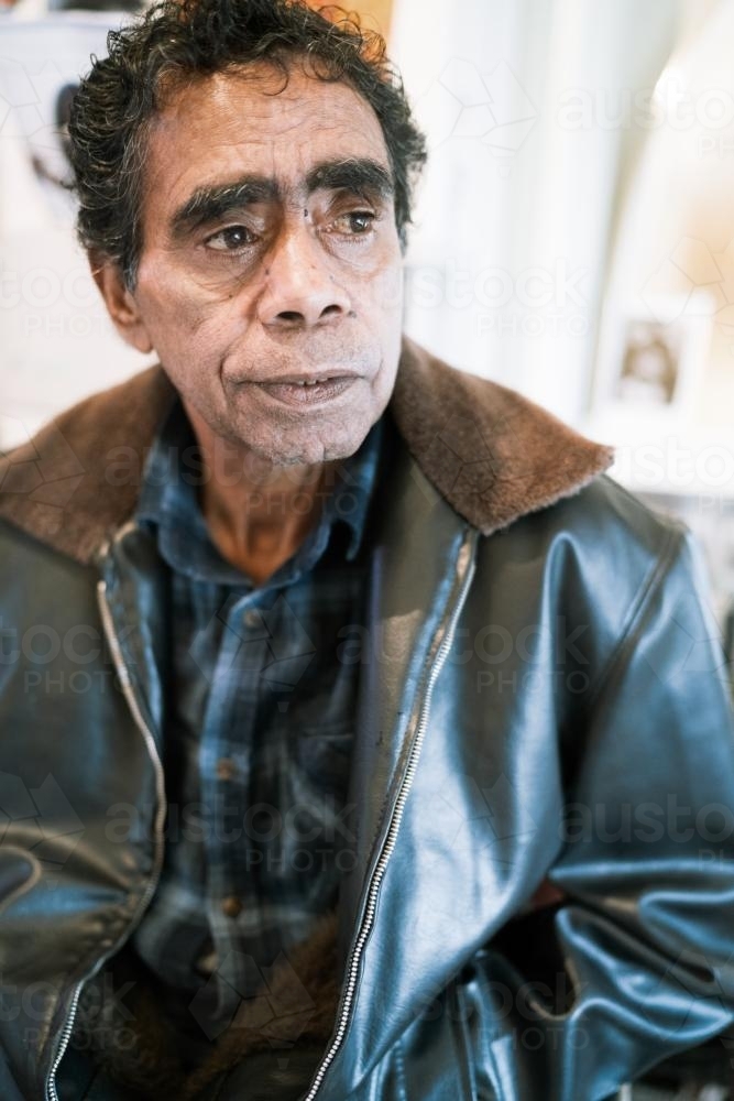 Close up of an Aboriginal Elder wearing a leather jacket - Australian Stock Image