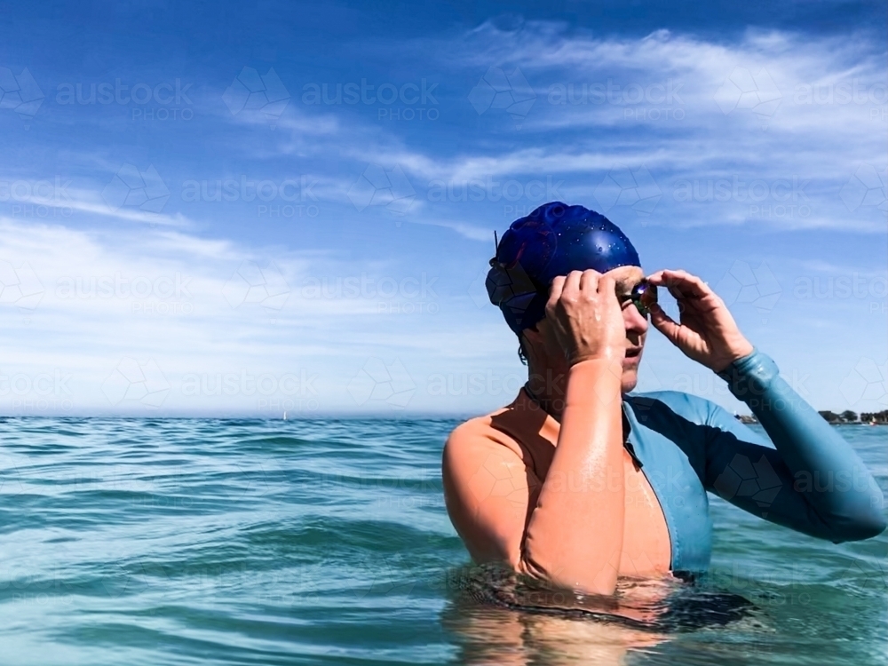 Close up of an open water Swimmer adjusting goggles - Australian Stock Image