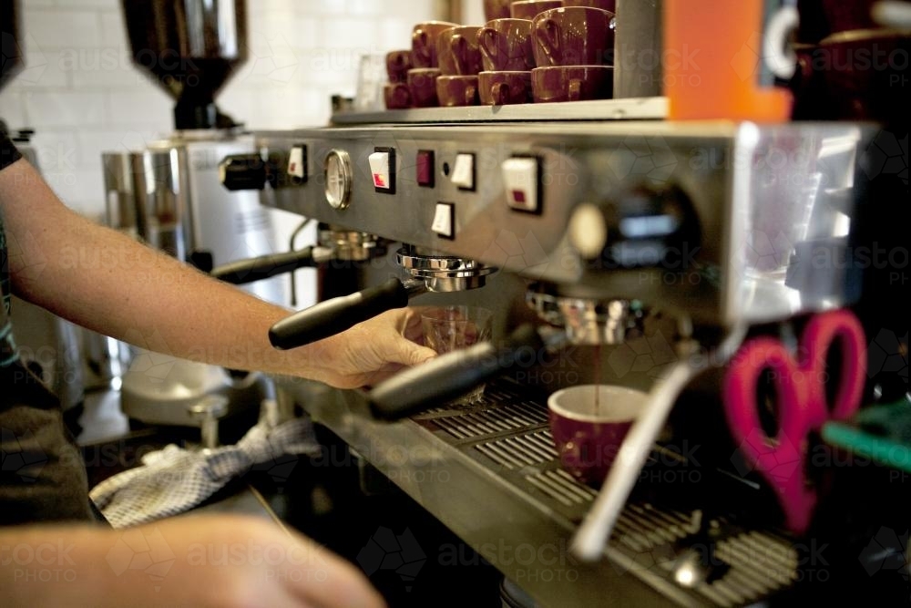 Close up of barista making coffee at a cafe - Australian Stock Image