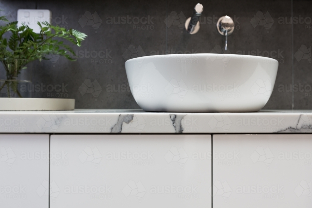 Close up of bathroom basin on a marble top vanity - Australian Stock Image