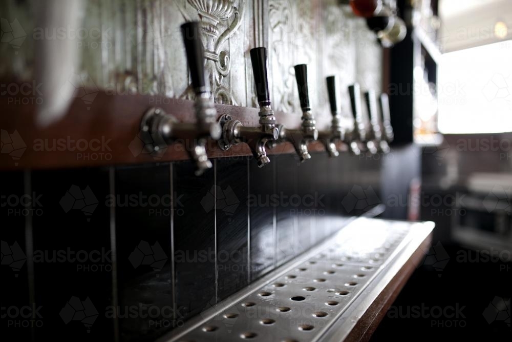 Close up of beer taps at local craft beer bar - Australian Stock Image