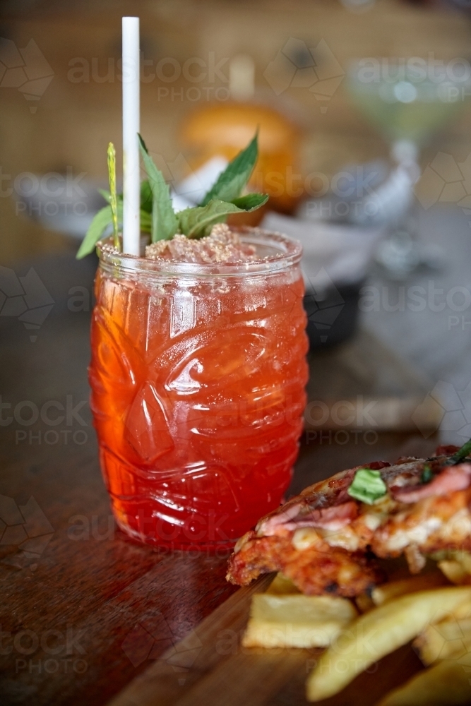 Close up of cocktail on table with meal - Australian Stock Image