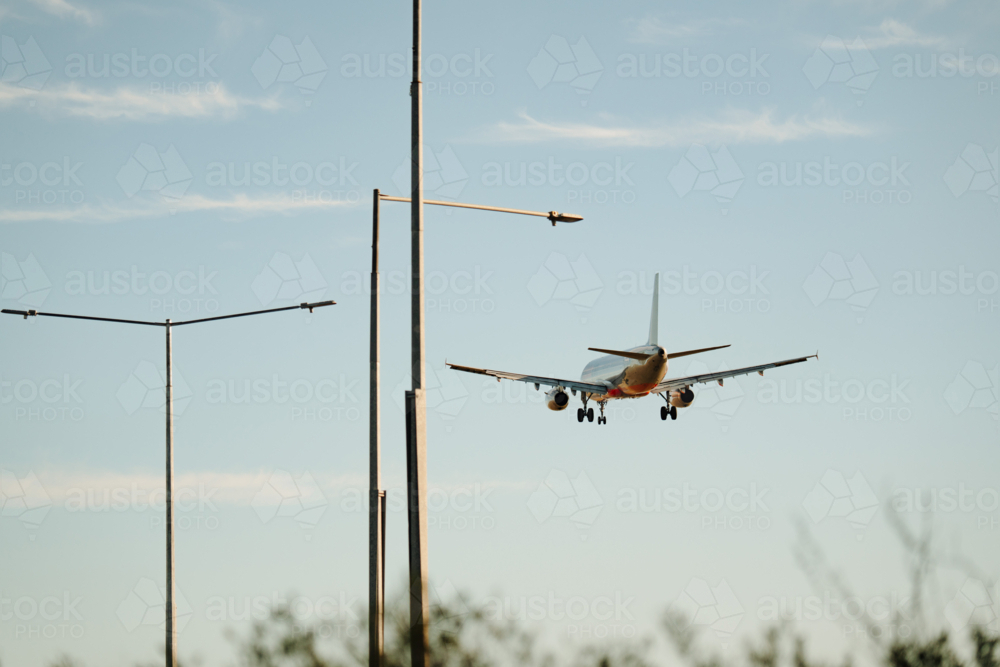 Close up of commercial airplane flying in the sky at daytime - Australian Stock Image