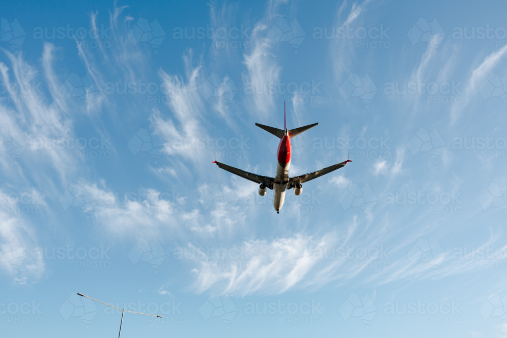 Close up of commercial airplane flying in the sky at daytime - Australian Stock Image