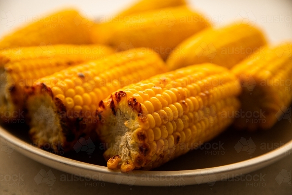 close up of corn in the cob on a plate - Australian Stock Image