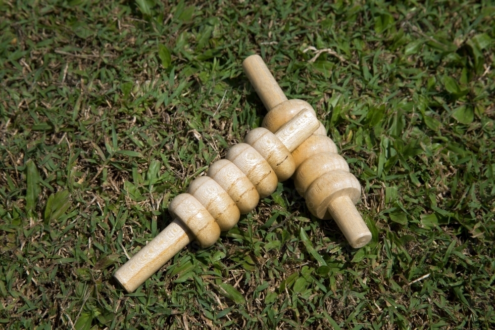 Close up of cricket bails lying on grass - Australian Stock Image