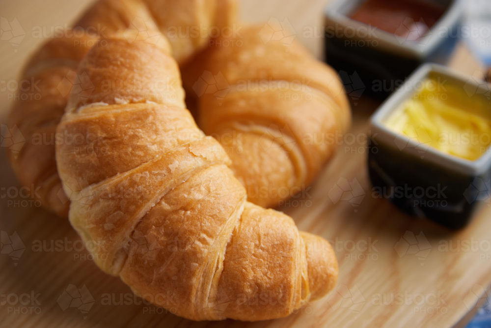 Close up of croissants with butter & jam - Australian Stock Image