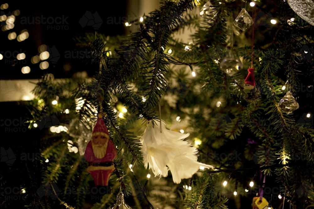 Close up of decorations on a christmas tree at night time - Australian Stock Image
