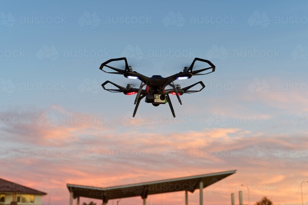 Close-up of drone, uav, rpas flying at sunset with copy space - Australian Stock Image