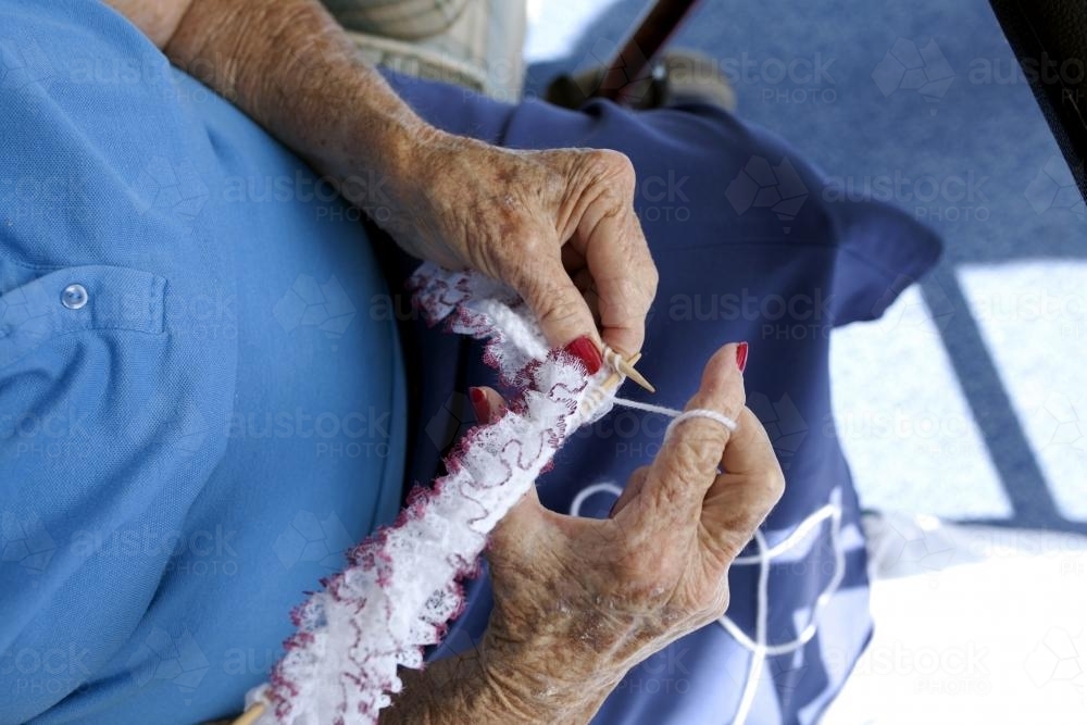 Close up of elderly lady knitting at retirement village - Australian Stock Image