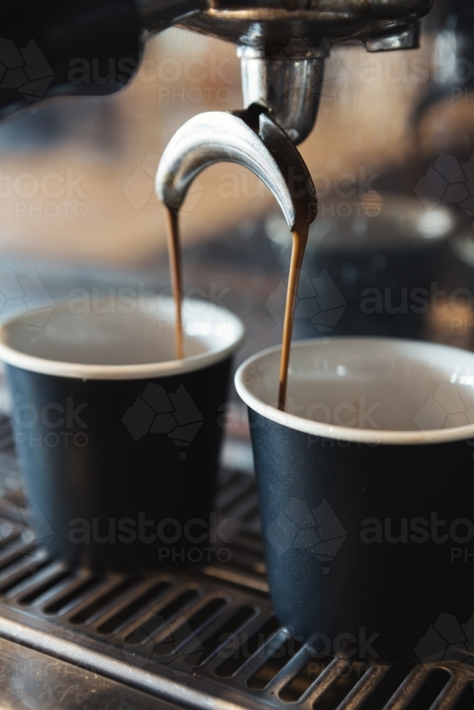 Close up of espresso machine making coffee in a cafe - Australian Stock Image
