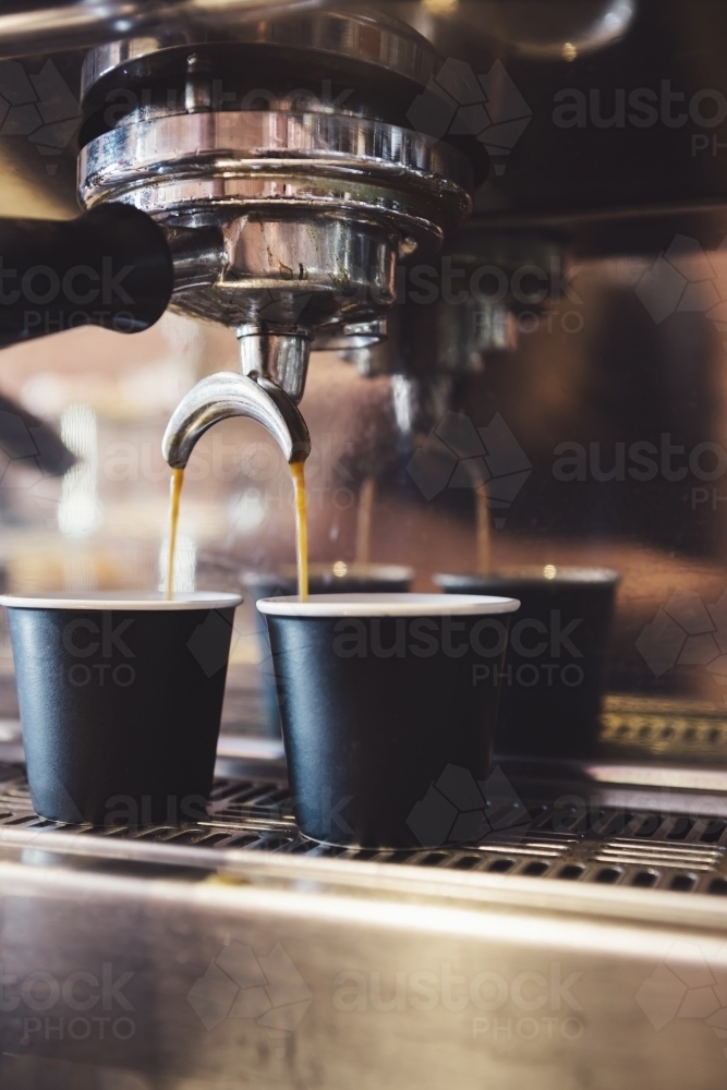 Close up of espresso machine making coffee in a cafe - Australian Stock Image
