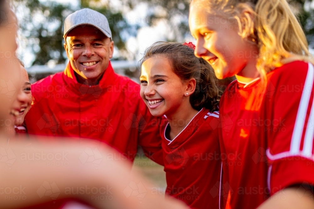 Close-up of female tween football team players in a huddle preparing for a game - Australian Stock Image