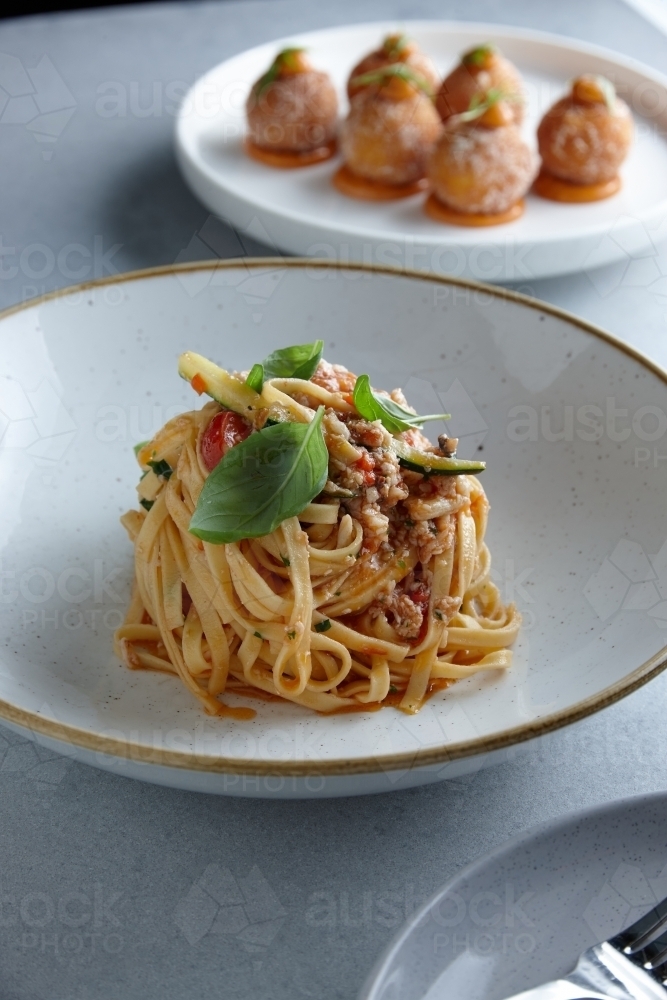 Close up of fresh pasta dish on table - Australian Stock Image