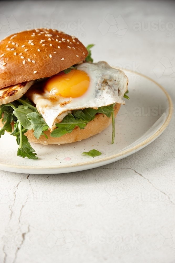 Close up of haloumi and egg burger on plate - Australian Stock Image