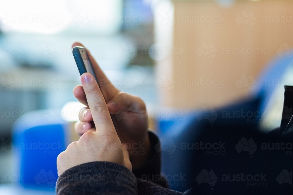 Close up of hands texting on mobile phone - Australian Stock Image