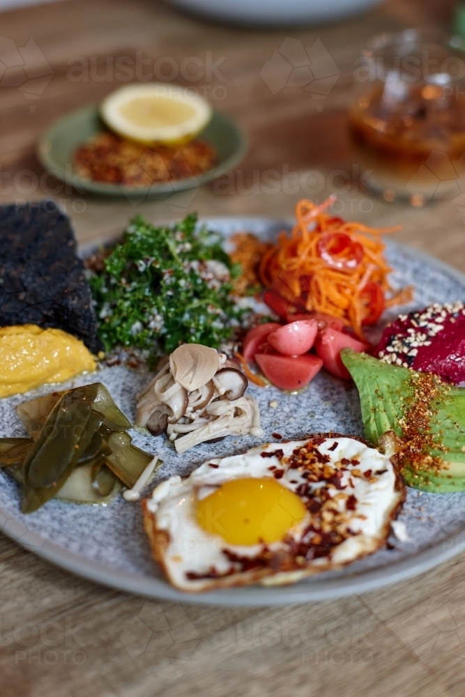 Close-up of healthy vegetarian meal on wooden table - Australian Stock Image