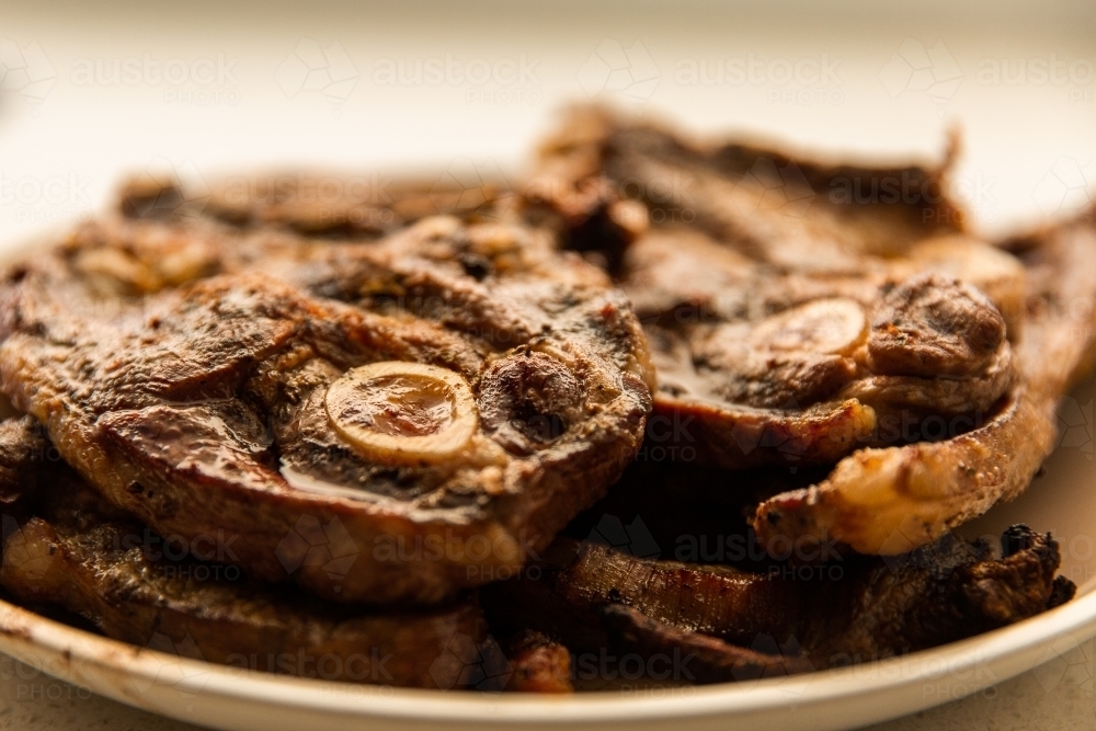 close up of lamb chops with bone marrow on a plate - Australian Stock Image